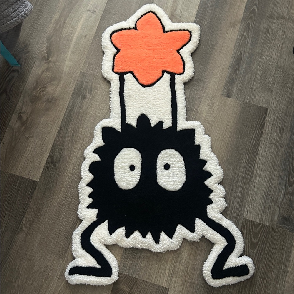 Quirky Black and White Rug with Orange Star. Soot. Sprite.
